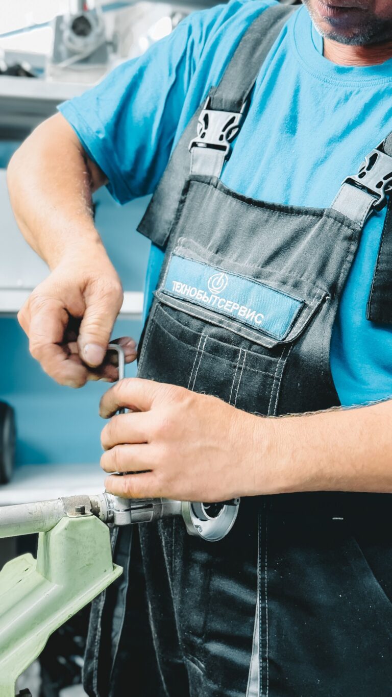 Plumber tightening a wrench on residential pipe