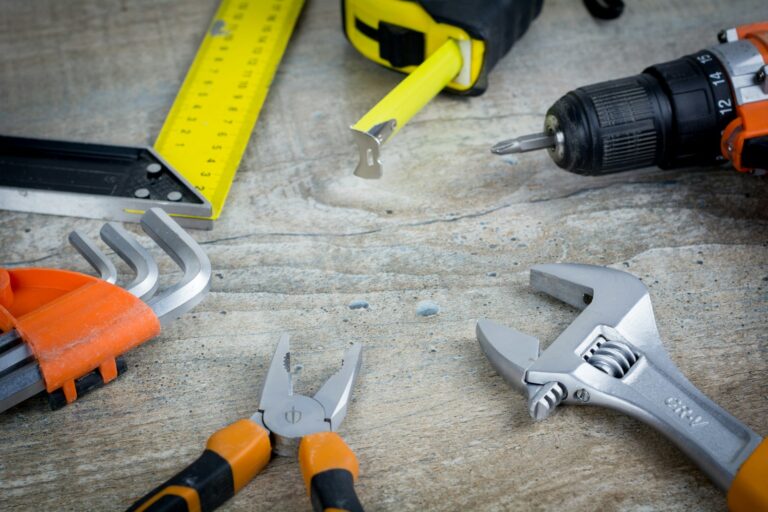 Variety of carpentry and repair tools laid on a workbench